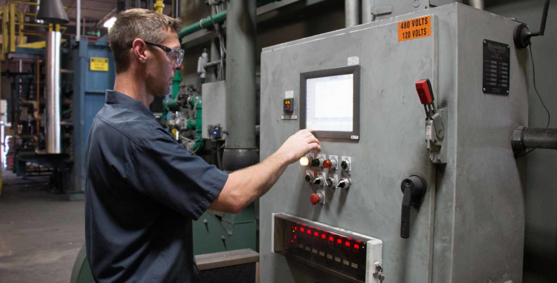 a worker operating the carburizing machine