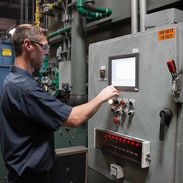 a worker operating the carburizing machine